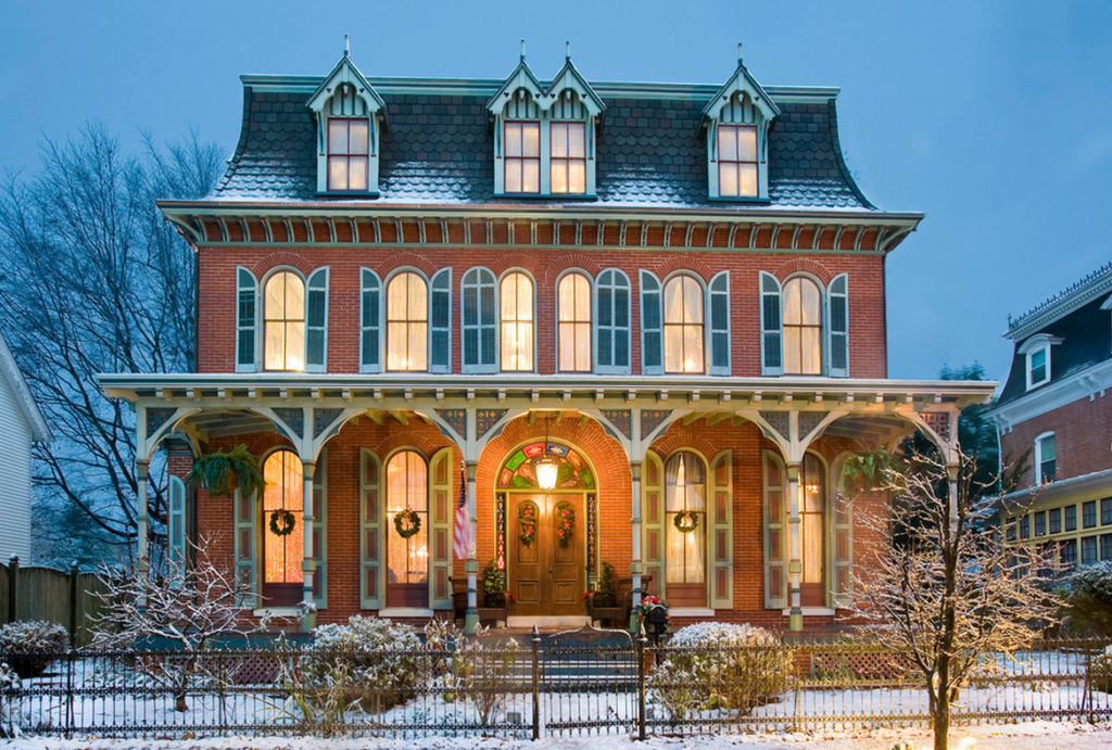 In this picture, a home's warm lighting contrasts the stark winter surroundings.