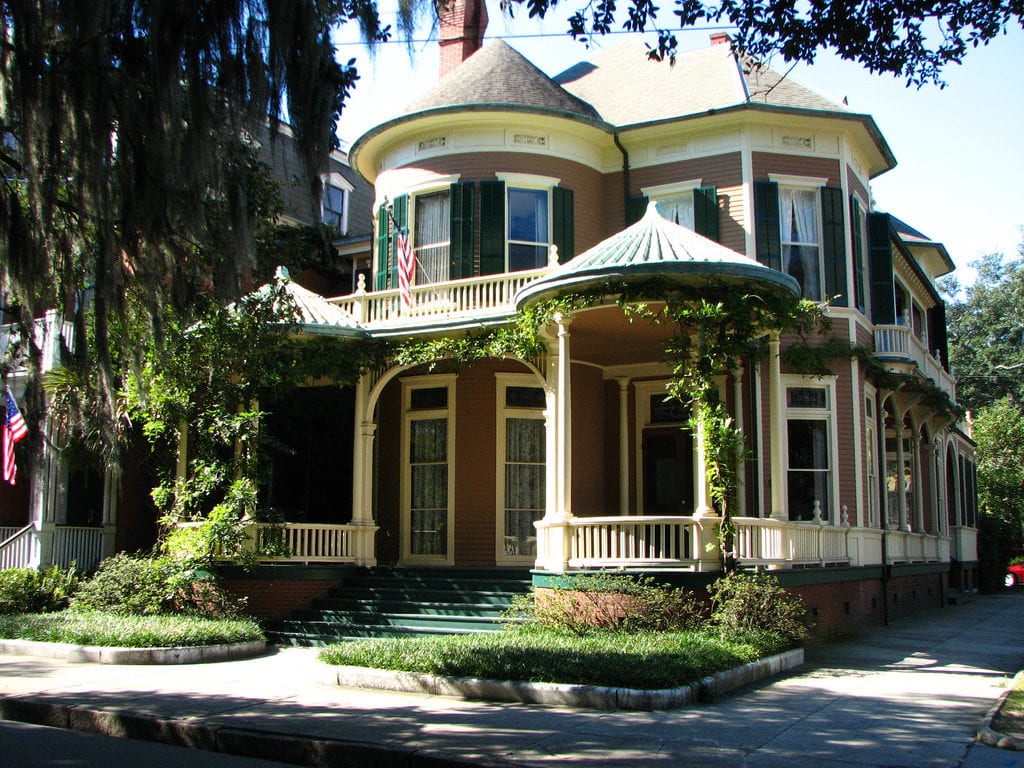 A Victorian Home sits on a quiet residential street.