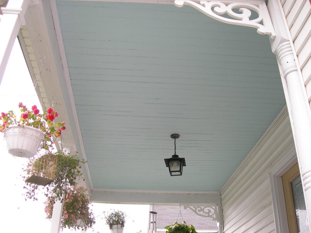 custom home with haint blue ceiling on porch.